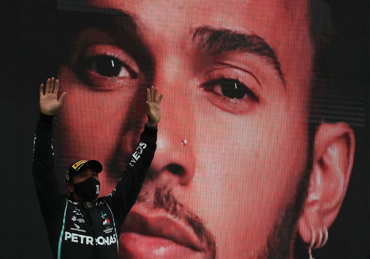 Race winner Lewis Hamilton of Great Britain and Mercedes GP celebrates his record-breaking 92nd race win on the podium during the F1 Grand Prix of Portugal at Autodromo Internacional do Algarve on October 25, 2020 in Portimao, Portugal.