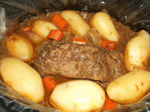 Roast, potatoes and carrots in a slow cooker.