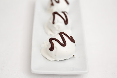 photo of three chocolate cake truffles lined up on a plate