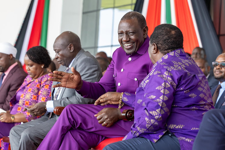 President William Ruto engaging with Cotu boss Francis Atwoli during the Labour Day celebrations at Uhuru Gardens on Wednesday, May 1, 2024.