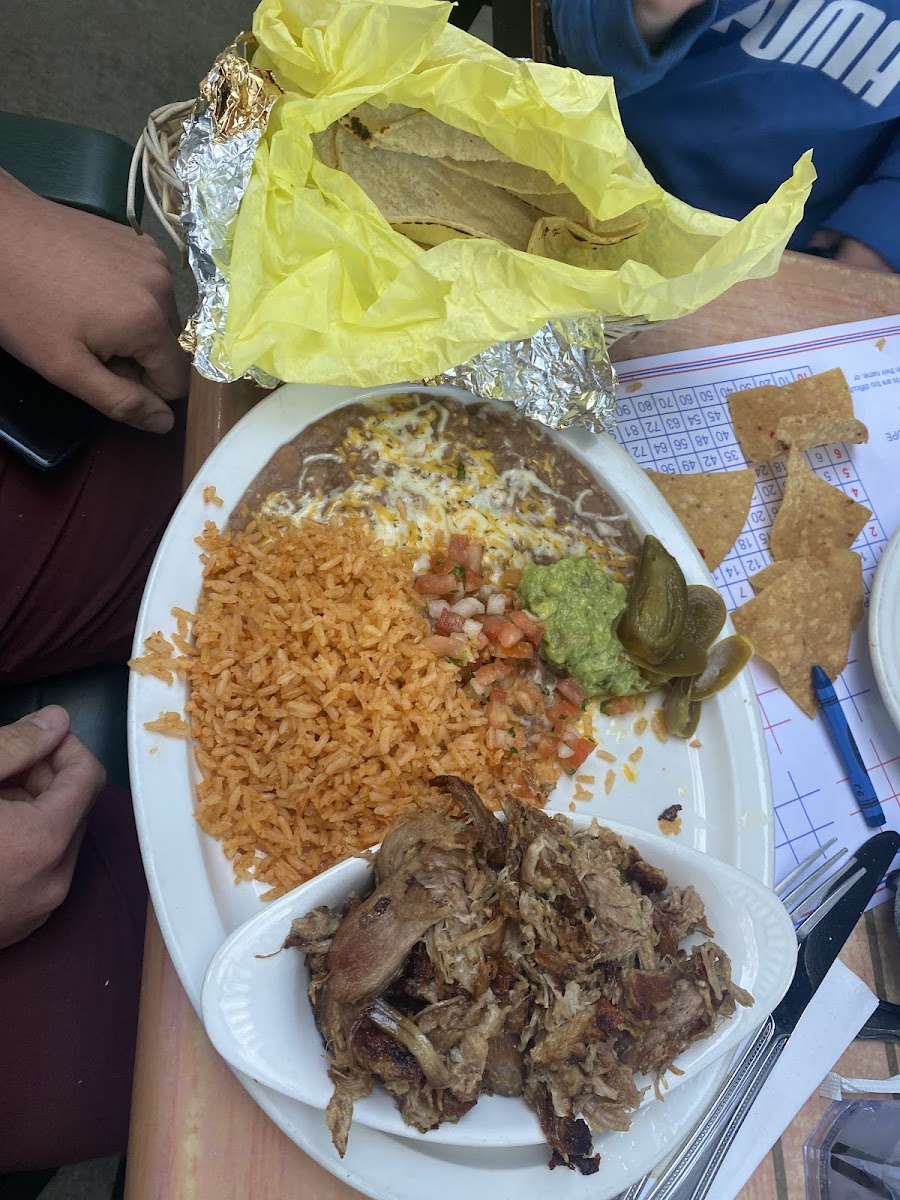 Carnitas with rice, beans, and corn tortillas