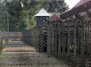 View of fences with concrete posts surrounding the barracks where deportees were detained at the concentration and death camp of Auschwitz established by the Nazis in April 1940.