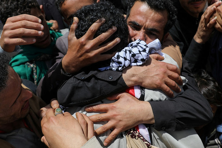 A freed prisoner is embraced after arriving at Sanaa Airport on an International Committee of the Red Cross (ICRC)-chartered plane, in Sanaa, Yemen, on Friday. Picture: REUTERS/KHALED ABDULLAH