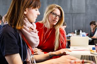 Two women looking at book