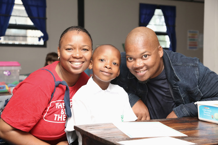 Bulelwa and Lindela Madlulela with their son, Zizibele (6) as he starts his first day of grade 1 at Cambridge Primary School, East London.