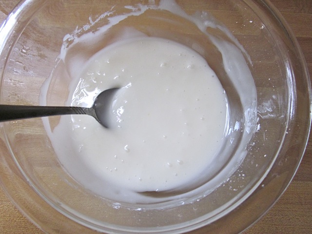 lemon glaze in mixing bowl with spoon 