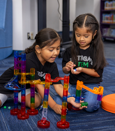 Two young students in the STEM program put together an obstacle course.