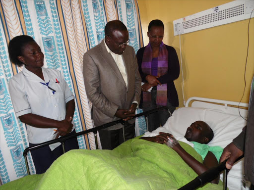 Senior Kenyatta National Hospital nursing officer Erina Bwibo, Health Cabinet Secretary Cleopa Mailu and CEO Lily Koros visit Sabdul Farah after an attack by al Shabaab in Mandera, December 27, 2015. /JOSEPH NDUNDA