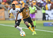 Kaizer Chiefs midfielder Lebogang Manyama slips the challengs of Orlando Pirates defender Innocent Maela in the Telkom Knockout quarterfinal Soweto derby at Moses Mabhida Stadium in Durban on Saturday.