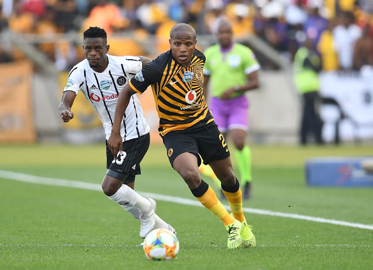 Kaizer Chiefs midfielder Lebogang Manyama slips the challengs of Orlando Pirates defender Innocent Maela in the Telkom Knockout quarterfinal Soweto derby at Moses Mabhida Stadium in Durban on Saturday.