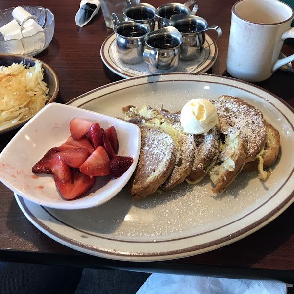 Gluten Free French Toast with strawberries and hash browns.