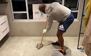 Siya Kolisi, seen mopping a floor, has challenged other men to take part in the cleaning challenge.