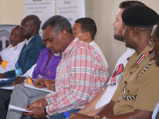 DPP Noordin Haji (in checked shirt) and other officers during the Kayole community dialogue yesterday /GORDON OUKO