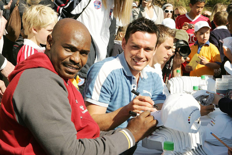 Fomrer Bafana Bafana player Linda Buthelezi and Piotr Trochowski during a Soccer Clinic coached by Philipp Lahm and Trochowski at the Deutsche Internationale Schule in Johannesburg, South Africa.