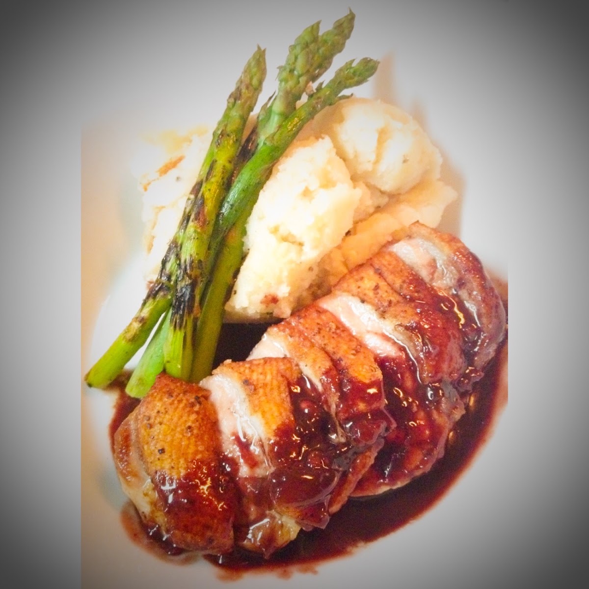 Seared duck breast with a port wine reduction, horseradish mashed potatoes and grilled asparagus.