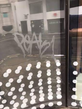 Acid etched grafitti removed from the windows at Zara, London. album cover