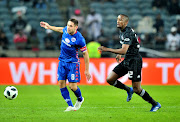 SuperSport United captain and midfielder Dean Furman vies for the ball under the watch of Linda Mntambo of Orlando Pirates during the Absa Premiership match at Orlando Stadium in Soweto, south of Johannesburg, on September 15 2018. 
