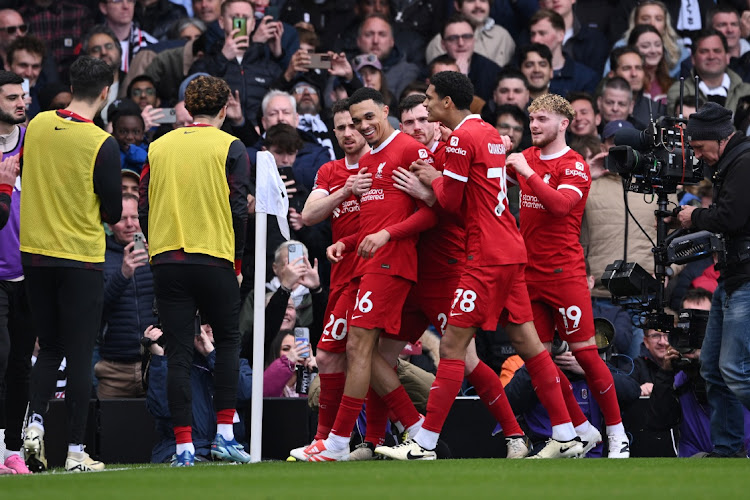 Trent Alexander-Arnold celebrates scoring Liverpool's first goal with teammates in the Premier League match against Fulham at Craven Cottage in London on Sunday.