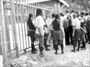 NO GO: Some Central Secondary School pupils were locked out of the school yard because they arrived  late for lessons. Pic. Alfred Moselakgomo. 15/01/2007. © Sowetan.