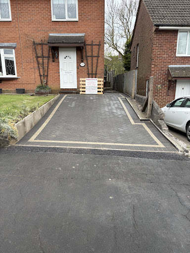 Block Paving Driveway With A Charcoal Border And Centre Also A Natrual Grey Line.