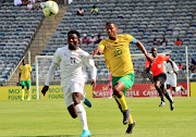 Togo Under-23's Kokou Avotor attempts to sprint clear of South Under-23 captain Rushwin Dortley in the U-23 Africa Cup of Nations second round, second leg qualifier at Orlando Stadium on October 30 2022.