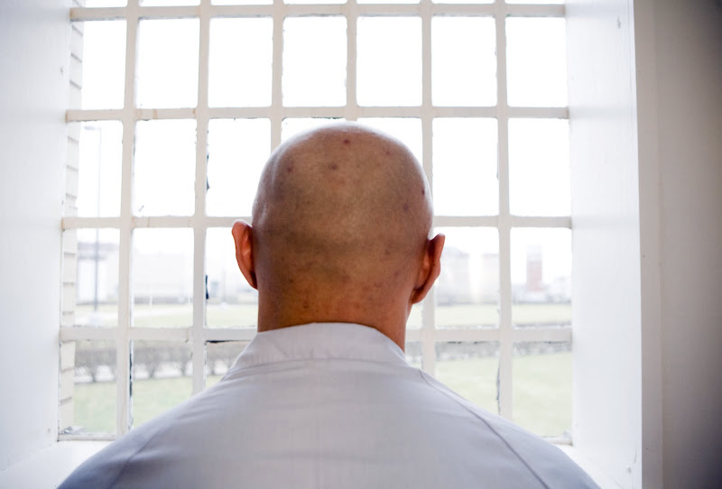 Andrew Suh looks out through the barred windows of the Pontiac Correctional Facility in Iris Shim's HOUSE OF SUH