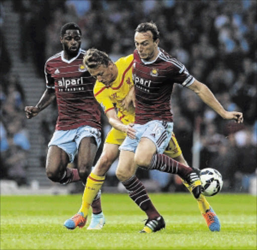 HAMMER DOWN : Liverpool's Lucas Leiva competes with West Ham United's Mark Noble during their Premiership match at Boleyn Ground in London Photo: John Powell/Getty Images