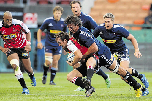 NOT VERY FRIENDLY: Eben Etzebeth of the Stormers tackles Michael Bondesio, centre, of the Lions, during the 2012 pre-season friendly match at Newlands Stadium in Cape Town