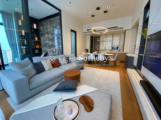 Modern living room with grey sofa and open kitchen in this luxury property for sale in Khlong Toei ($1,145,510 - 108 m²)