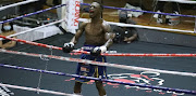 Lusanda Komanisi celebrates after defeating Kabelo Bikitsha during a clash at the Orient Theatre.