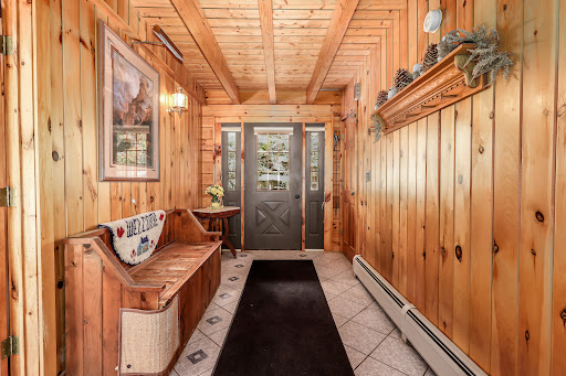 Buy this luxury house in Brookfield (United States) - Wooden entryway with bench and glass door