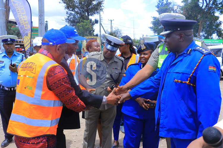 Matatu owners association Chairman Albert Karakacha , Head of traffic operations Serah Khoki and other stakeholders shake hands after briefing the media during the Launch of Matatu safety measures for road users at Makongeni on Nairobi March 7, 2024