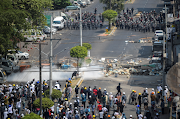 Demonstrators clash with riot police officers during a protest against the military coup in Yangon, Myanmar, on February 28, 2021. 
