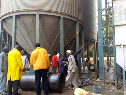 Engineers and other workers examine the damage at the NCPB depot in Eldoret, Uasin Gishu county, following a fire on January 4, 2018. /Mathews Ndanyi