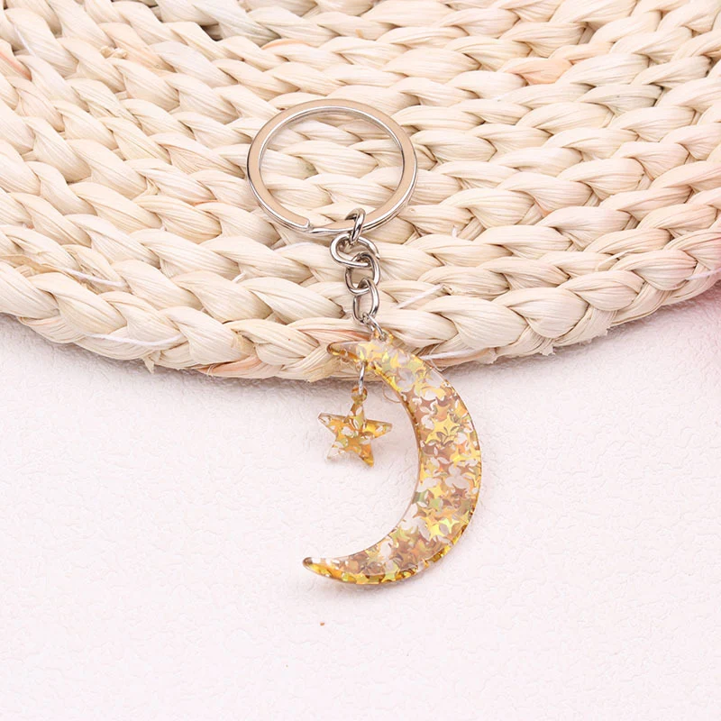 Llavero colgante acrílico sol luna europeo y americano, creativo y simple, un accesorio elegante para llaves y bolsos.