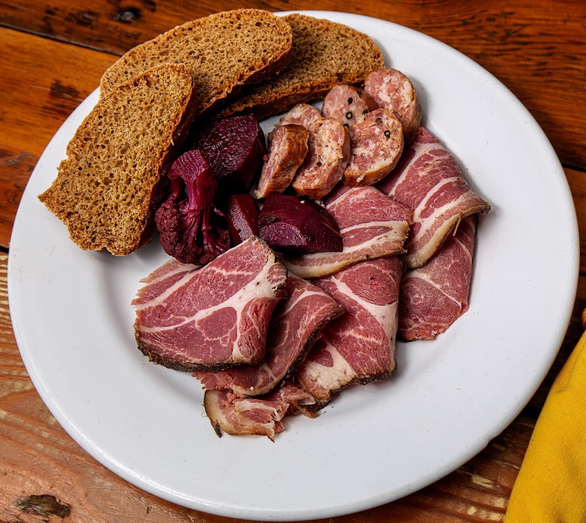 Cured Meat plate with soppressata, Proscuitto, pickled root vegetables, gluten free bread