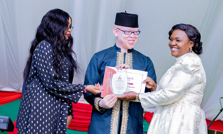 Pastor Dorcas Rigathi hands the certificate and award of service to Government Spokesman Isaac Mwaura, who is together with the wife, during the Heroes and Heroines Awards 2024 on April 12, 2024.