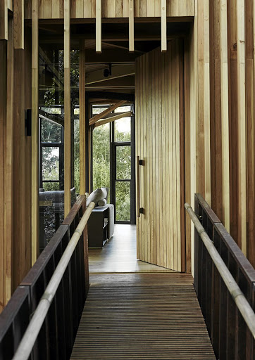 You enter via a suspended timber and steel ramp, which enhances the sense that the building is floating.