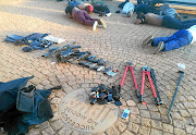 Seized weapons and some of the 40 men who were arrested for the attack on the International Pentecostal Holiness Church.  