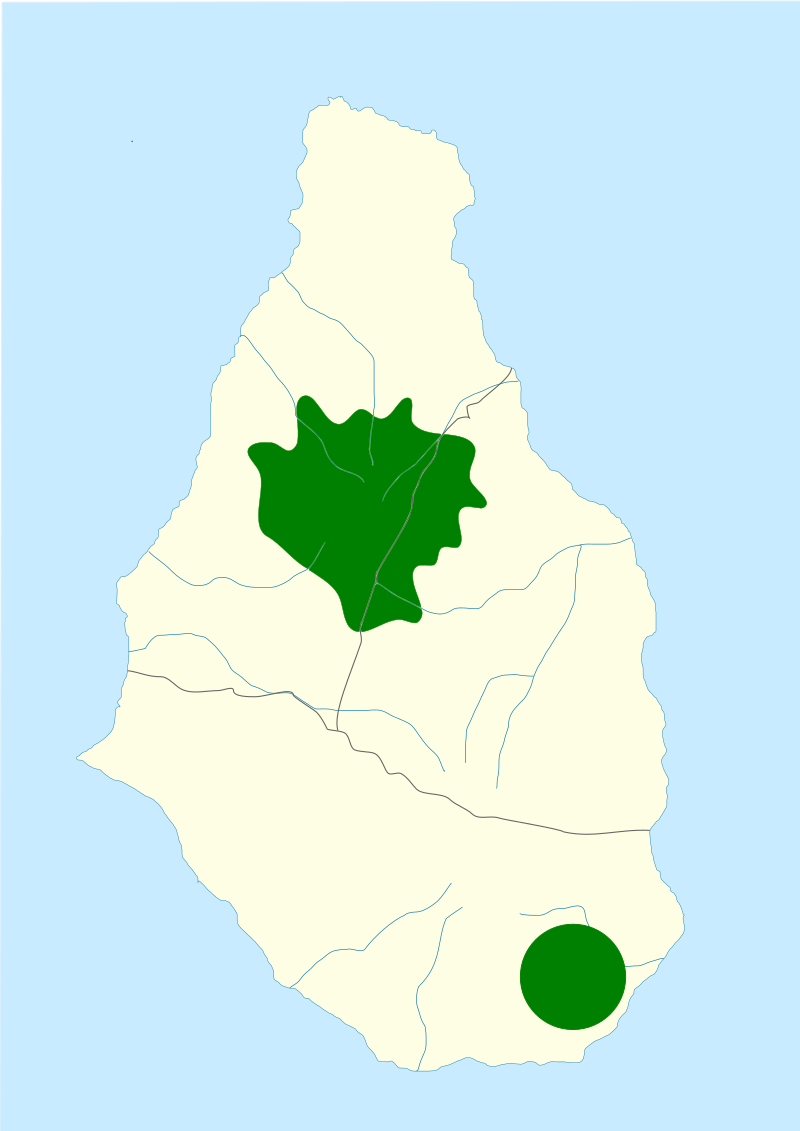 A map of the small ovular island of Montserrat is shown, with a relatively large jagged habitat near the top middle of the island and a small round habitat near the south-east end of the island shown in green. 