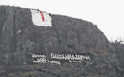  A sign and words painted by Mancoba Seven Angels Ministry on a mountain behind Khalinyanga village.