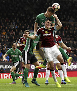 Lincoln City's hero Sean Raggett beats Michael Keane of Burnley to the ball in FA Cup action.