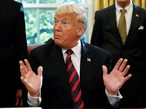 U.S. President Donald Trump talks to reporters about the killing of journalist Jamal Khashoggi in Turkey during a bill signing ceremony at the White House in Washington. REUTERS