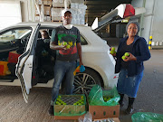 Vivian Mjongile, Mexin Madonci and Lilian Bron-Davis receiving donated fruit in Piketberg.