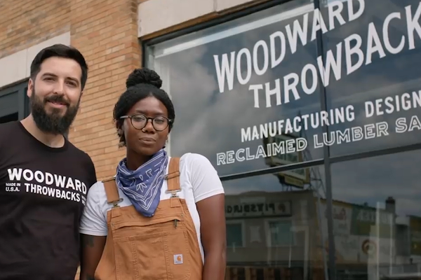 Bo Shepherd and Kyle Dubay pose in front of their store, Woodward Throwbacks.