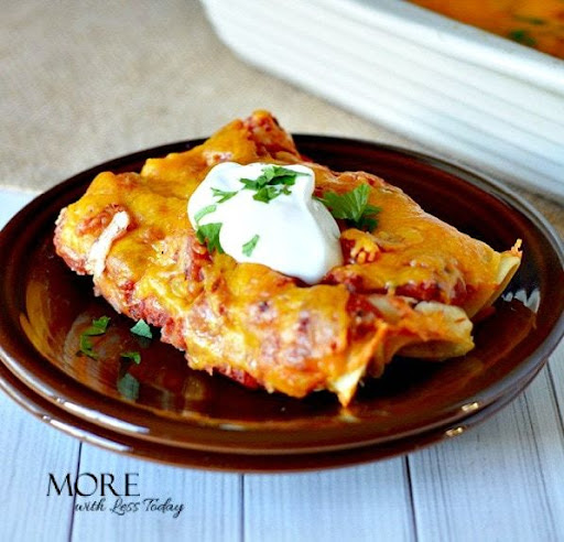 A serving of Easy Chicken Enchiladas on a brown plate.