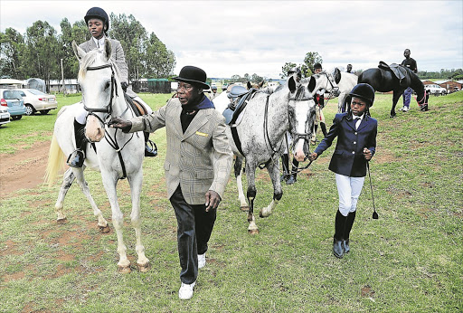 Hlobisile Mashaba, trainer Enos Mafokate and Thabang Mafokate during the Soweto Classic showjumping in Cullinan, east of Pretoria. Photo Veli Nhlapo © Sowetan