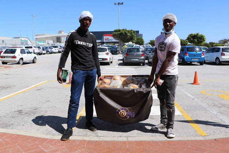 Abongile Ngqezu, left, co-owner of Food At Work, with one of his employees, Simbulele Links.