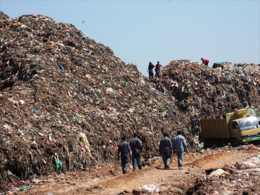 Nairobi county government officials walk into Dandora dumpsite after the launch of a cleanup with NYS in December last year. Image: FILE