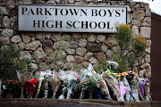 Parktown boys with flowers left by the parents and public generaly for the death of Enoch Mpianzi last week. 